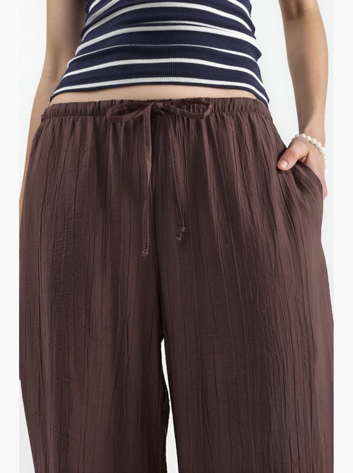 Pantaloni in tessuto a gamba larga da donna busem - Kiabi Pantaloni in tessuto a gamba larga da donna busem - Kiabi