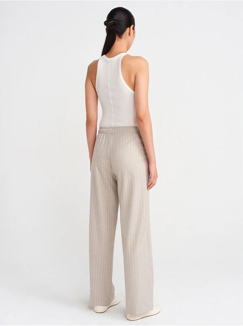 Pantaloni in tessuto a righe a gamba ampia dilvin Sabbia - Kiabi