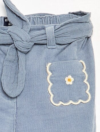 Pantaloni in velluto a coste con tasche ricamate
