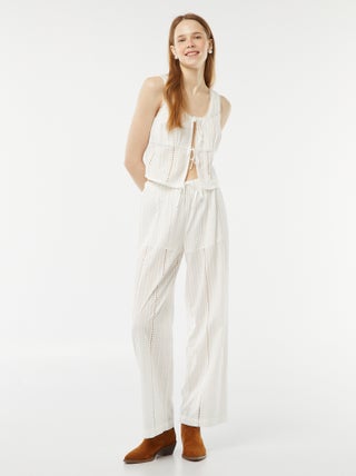 Pantaloni larghi con ricami a punto inglese e maglia traforata