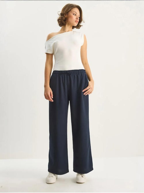 Pantaloni palazzo a gamba ampia con chiusura a laccio lucci - Kiabi Pantaloni palazzo a gamba ampia con chiusura a laccio lucci - Kiabi