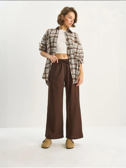 Pantaloni palazzo a gamba ampia con chiusura a laccio lucci - Kiabi Pantaloni palazzo a gamba ampia con chiusura a laccio lucci - Kiabi