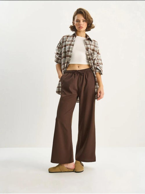 Pantaloni palazzo a gamba ampia con chiusura a laccio lucci - Kiabi Pantaloni palazzo a gamba ampia con chiusura a laccio lucci - Kiabi