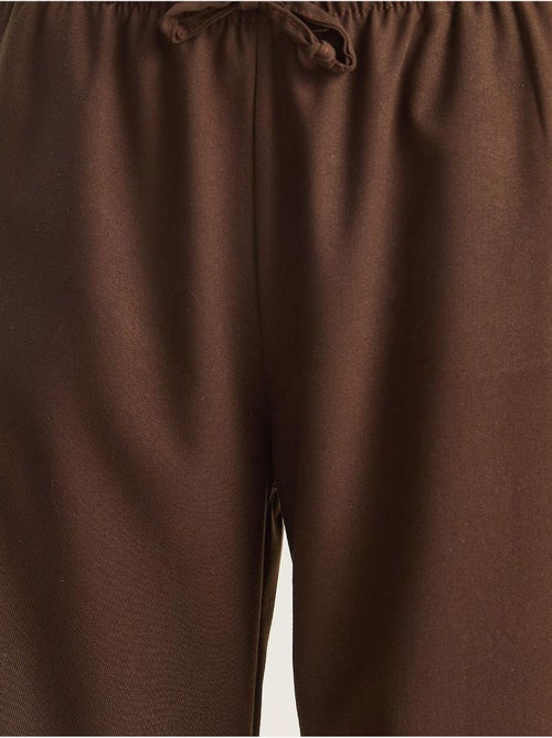 Pantaloni palazzo a gamba ampia con chiusura a laccio lucci - Kiabi Pantaloni palazzo a gamba ampia con chiusura a laccio lucci - Kiabi