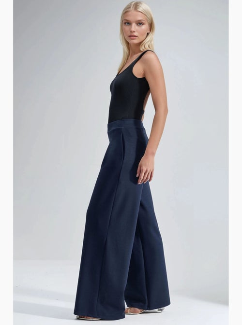 Pantaloni palazzo plissettati con vita elasticizzata busem - Kiabi Pantaloni palazzo plissettati con vita elasticizzata busem - Kiabi