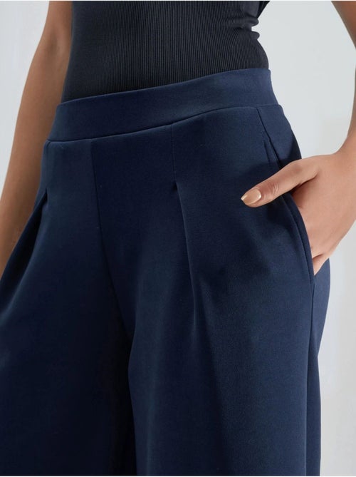 Pantaloni palazzo plissettati con vita elasticizzata busem - Kiabi Pantaloni palazzo plissettati con vita elasticizzata busem - Kiabi