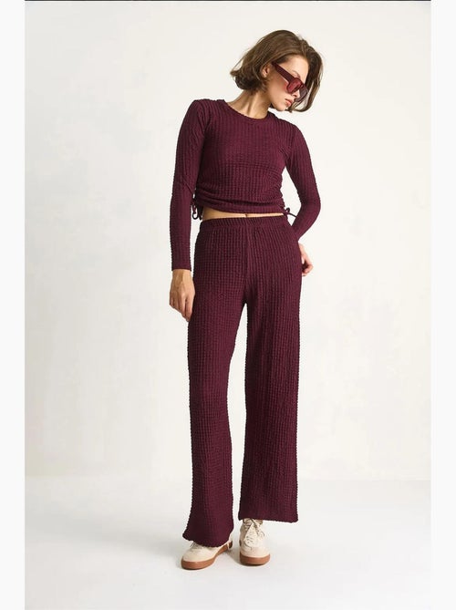 Set co-ord a due pezzi aderente con pantaloni a zampa lucci - Kiabi Set co-ord a due pezzi aderente con pantaloni a zampa lucci - Kiabi
