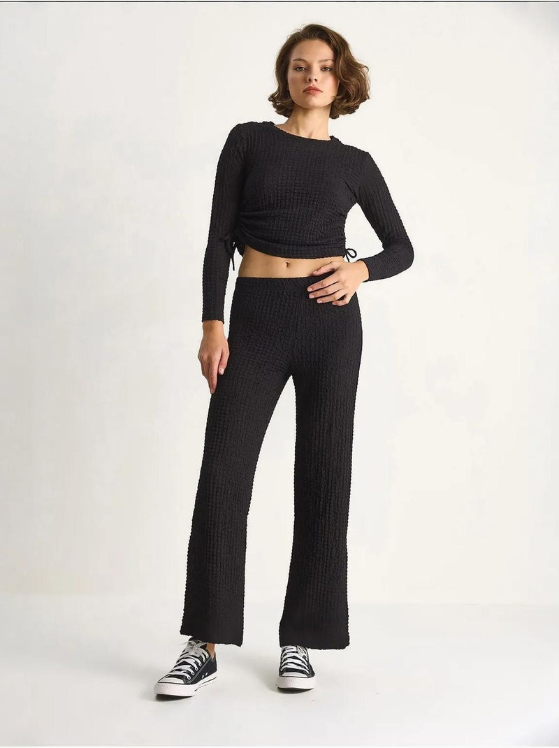 Set co-ord a due pezzi aderente con pantaloni a zampa lucci Nero - Kiabi