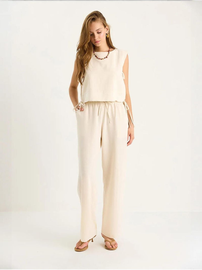 Set co-ord a due pezzi con girocollo, chiusura con laccetti e pantaloni a gamba ampia lucci Beige argilla - Kiabi