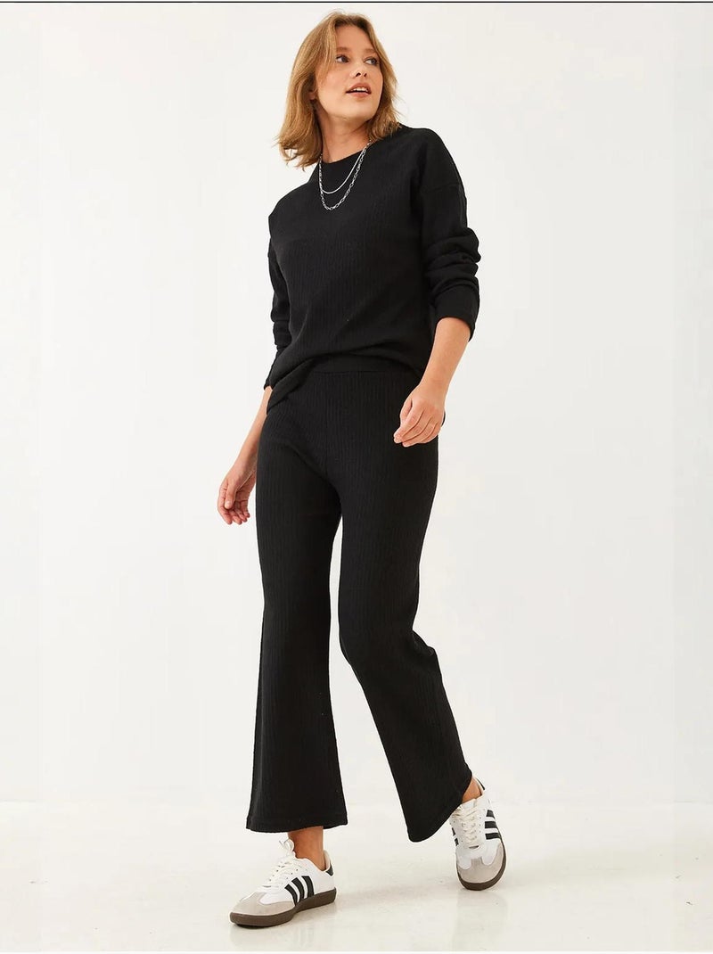 Set coordinato in maglia a costine testurizzata con maglione girocollo e pantaloni lucci Nero - Kiabi