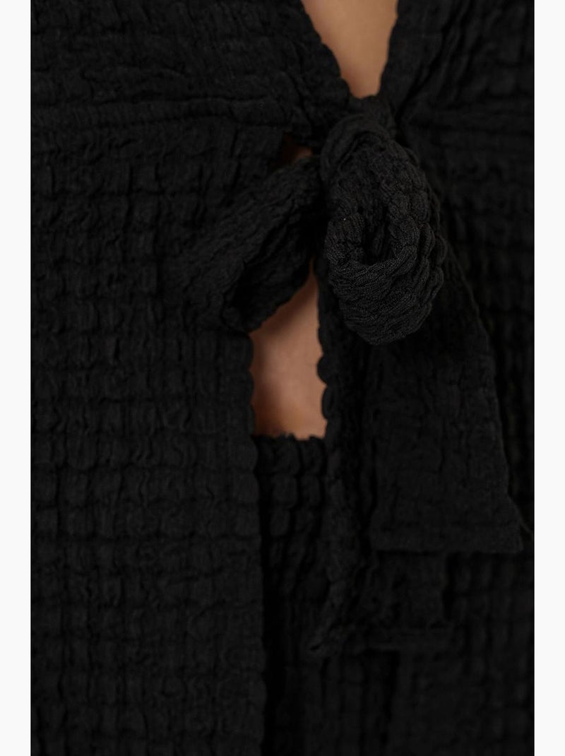 Set due pezzi con top testurizzato a maniche lunghe con scollo a v e pantaloni a zampa bdart Nero - Kiabi