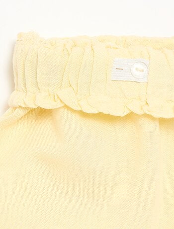 Short a tinta unita con fiocco decorativo