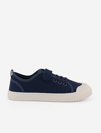 Sneakers in tela con strappo