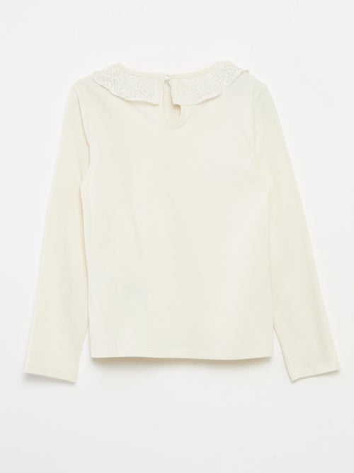 T-shirt a tinta unita con ampio collo a volant e paillettes - Kiabi