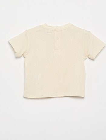 T-shirt a tinta unita con fiori fantasia sul colletto