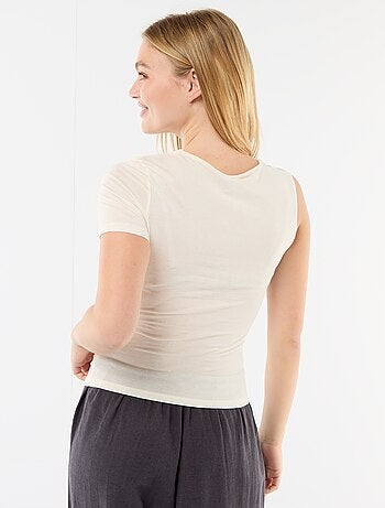 T-shirt asimmetrica con drappeggio sulla spalla