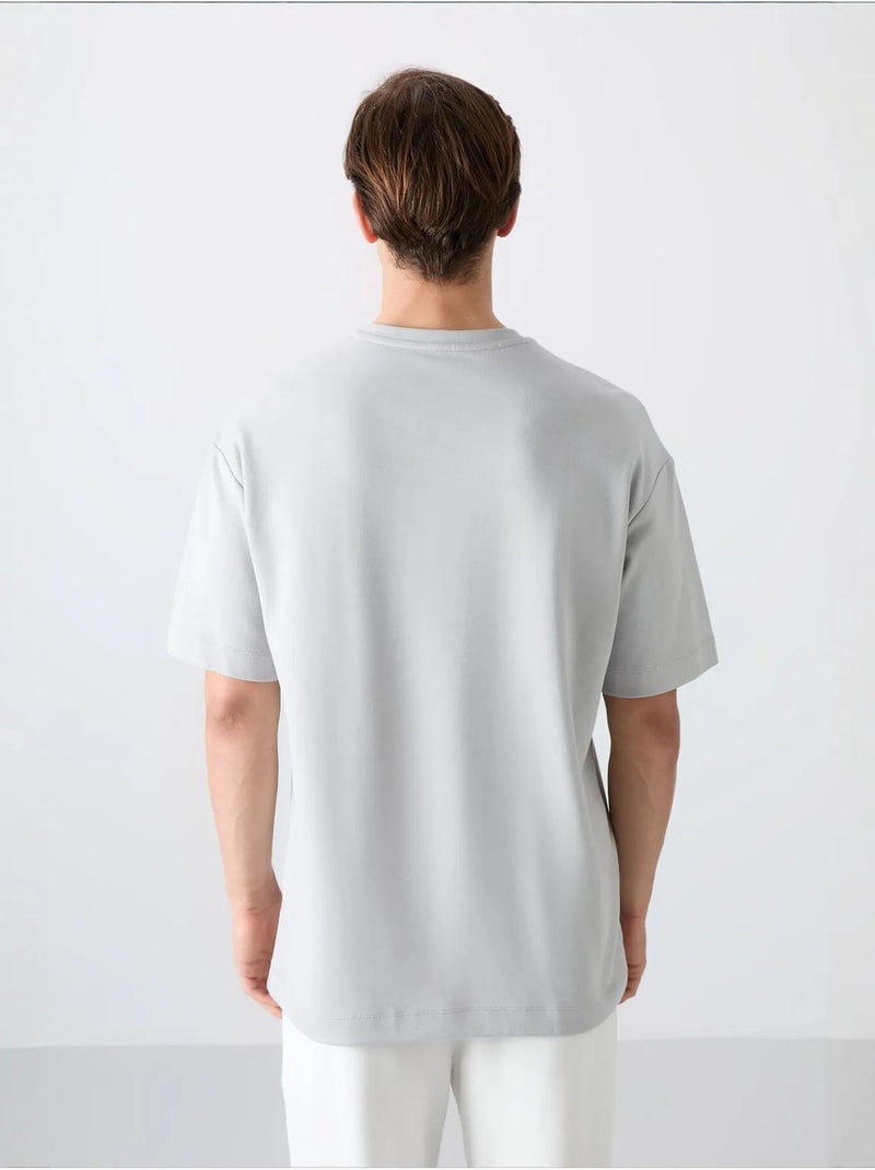 T-shirt girocollo oversize in misto cotone tommy Grigio chiaro - Kiabi