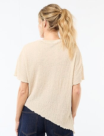 T-shirt in maglia con base asimmetrica