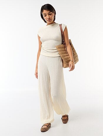 Top stretch asimmetrico a tinta unita senza maniche