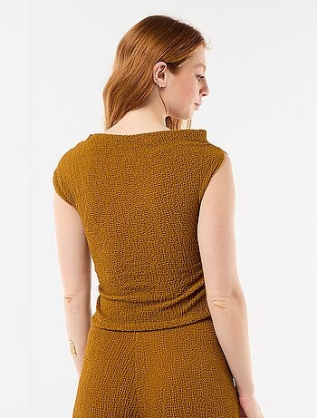 Top stretch asimmetrico a tinta unita senza maniche