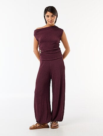 Top stretch asimmetrico a tinta unita senza maniche