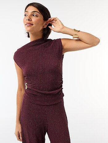 Top stretch asimmetrico a tinta unita senza maniche