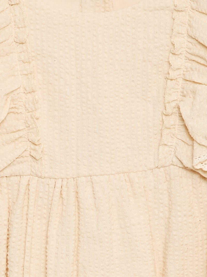 Tutina con tessuto effetto goffrato e volant Beige - Kiabi